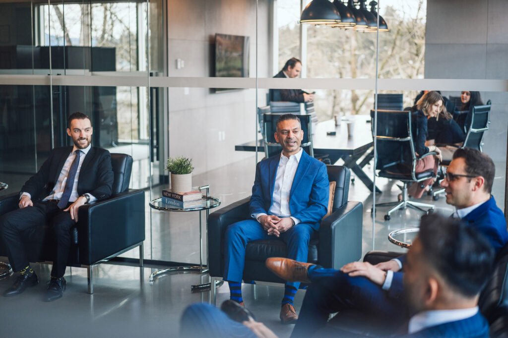 Several business people site in an office reception having a conversation