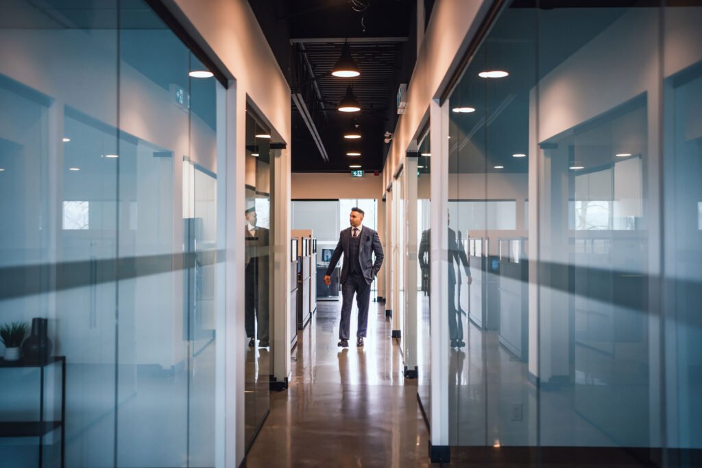 A business person walking down an office hallway