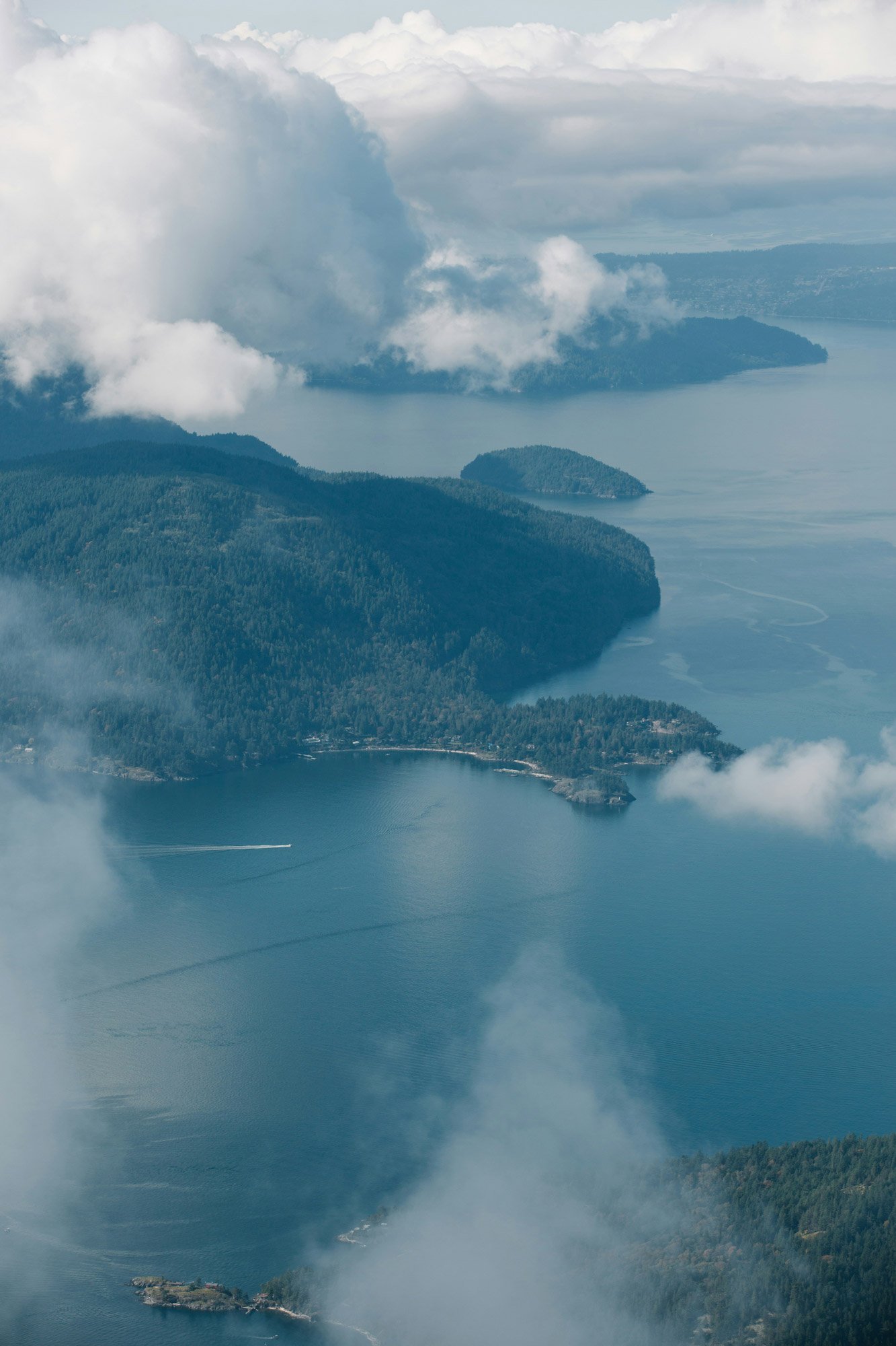 Arial view of islands in the ocean through clouds