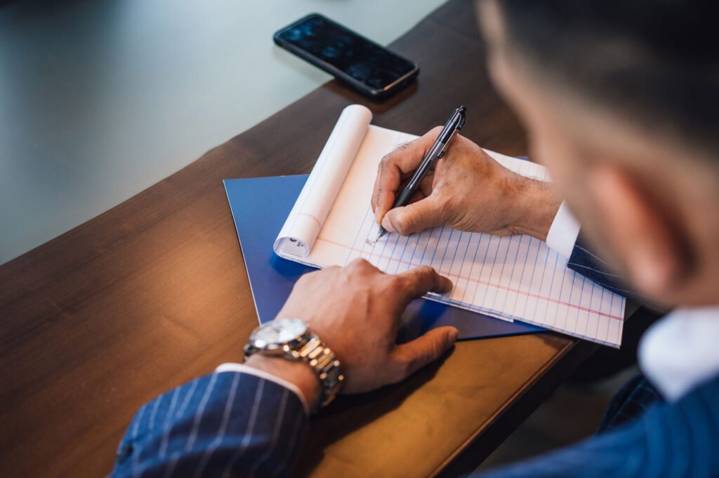 person writing on a notepad
