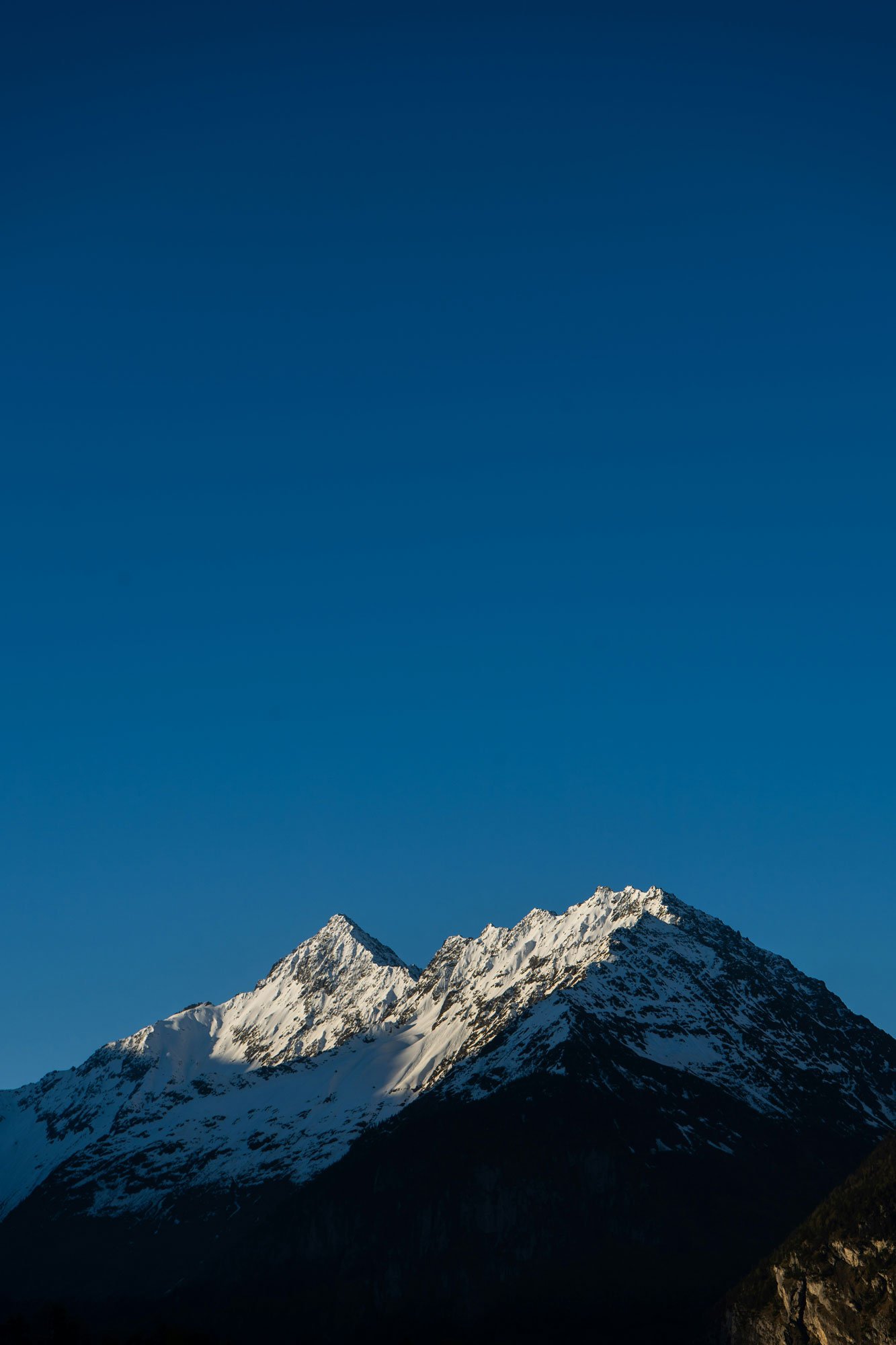 Snow capped mountains against a blue sky